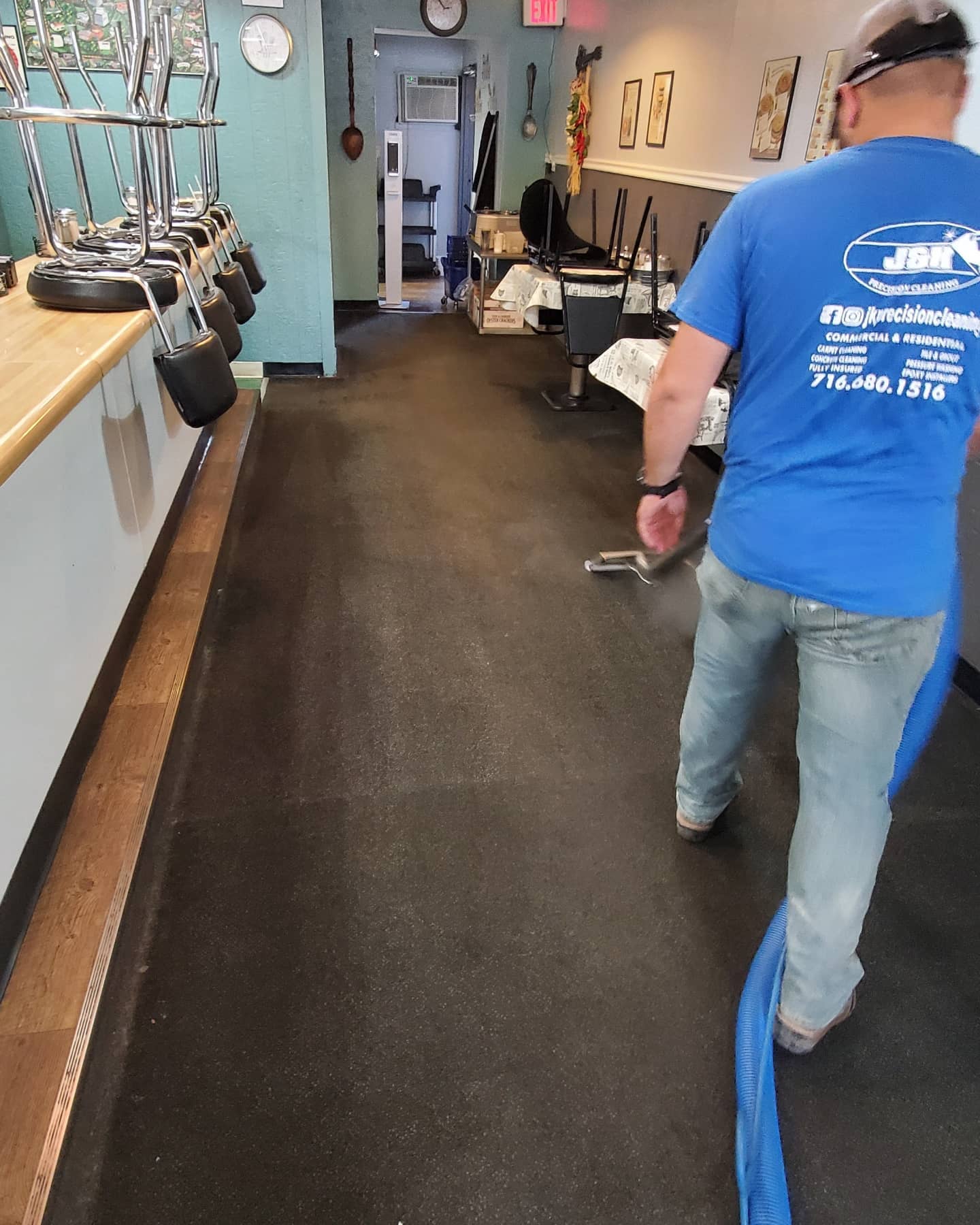 J&K technician deep-cleaning a commercial carpet on site